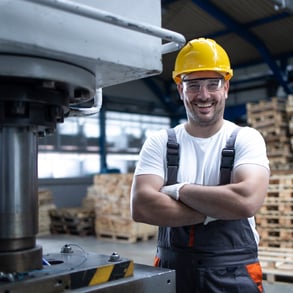 Metal manufacturing employee smiling