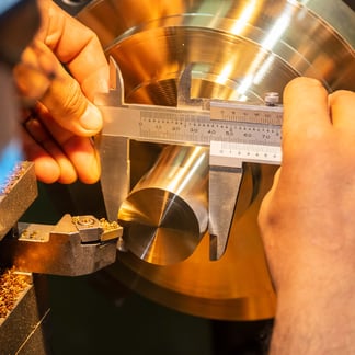 Brass metal project, hands measuring width