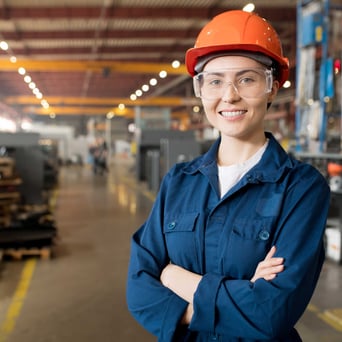 Woman smiling in metal manufacturing plant