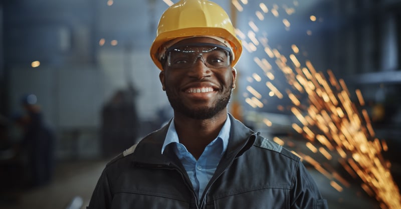 Man smiling in metal manufacturing plant