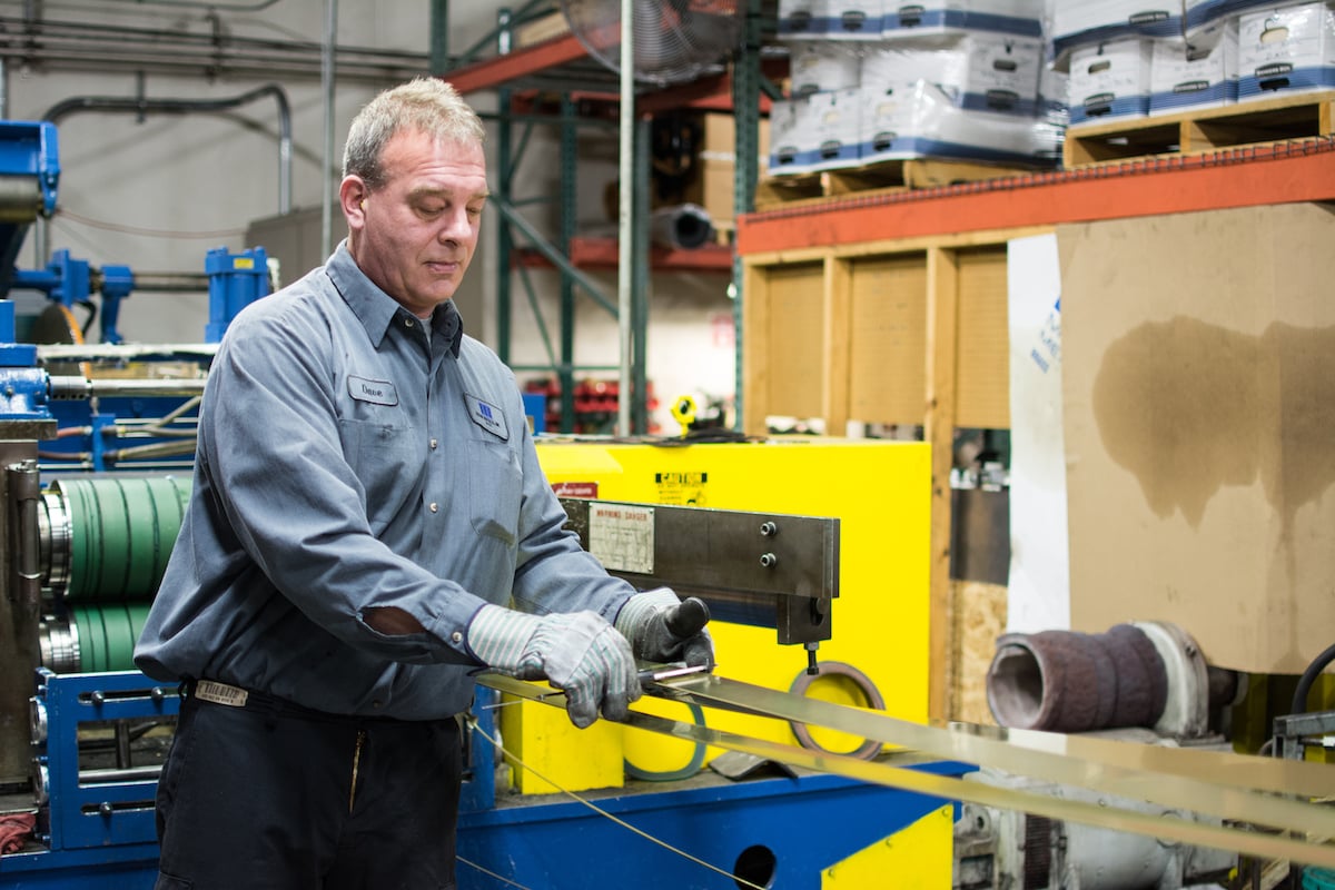 mead metal service center employee measuring width of material