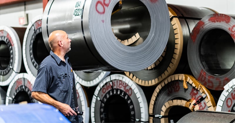 Mead metals employee loading a steel coil for shipment