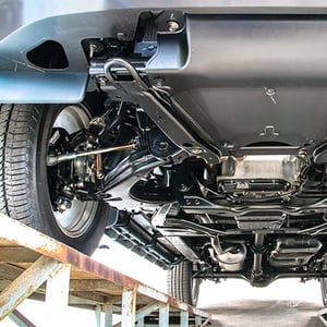 View of the underside of an automotive vehicle during manufacture.