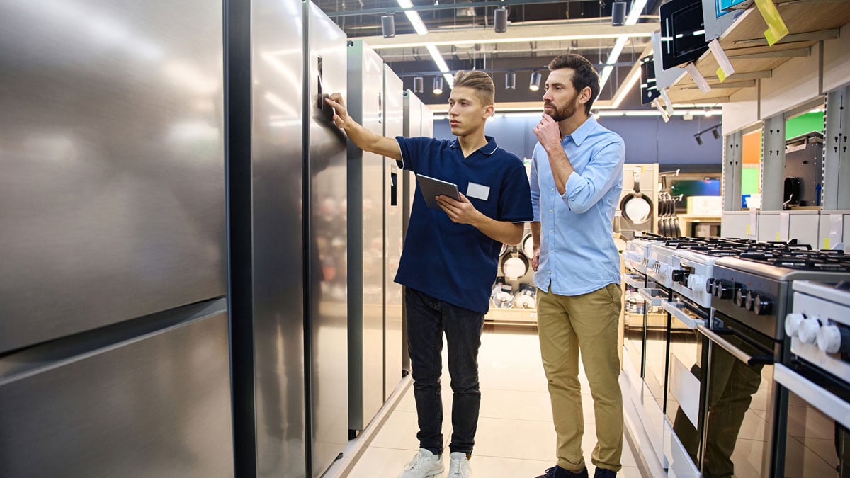man-looking-at-appliances-in-showroom