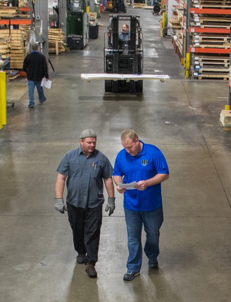 Two employees walking in the warehouse