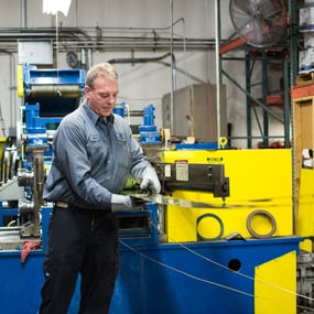 Person using metal slitting machine