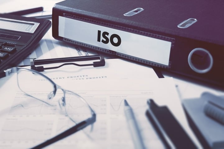 Office folder with inscription ISO - International Organization for Standardization - on Office Desktop with Office Supplies. Business Concept on Blurred Background. Toned Image..jpeg