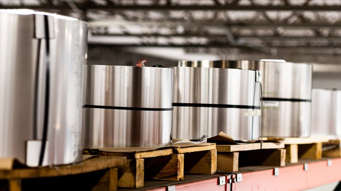 Rolls of steel placed on panels in warehouse